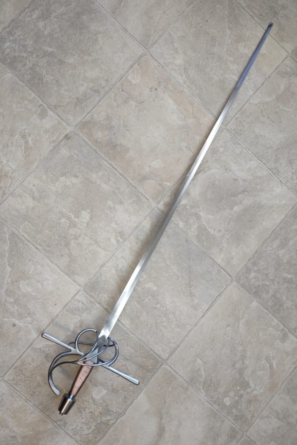 Fedoruk three ring rapier, HEMA rapier Copper wire wrapped grip. Standard 42" blade; 48" overall length. Bright finish. COB is 5.5 cm in front of guard. A mere 1300 grams. Will pass SCA flex tests.