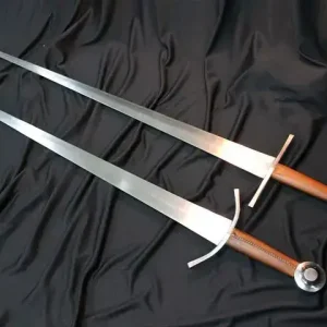 2 Kvetun arming swords. One with a straight crossguard, another with a curved crossguard.